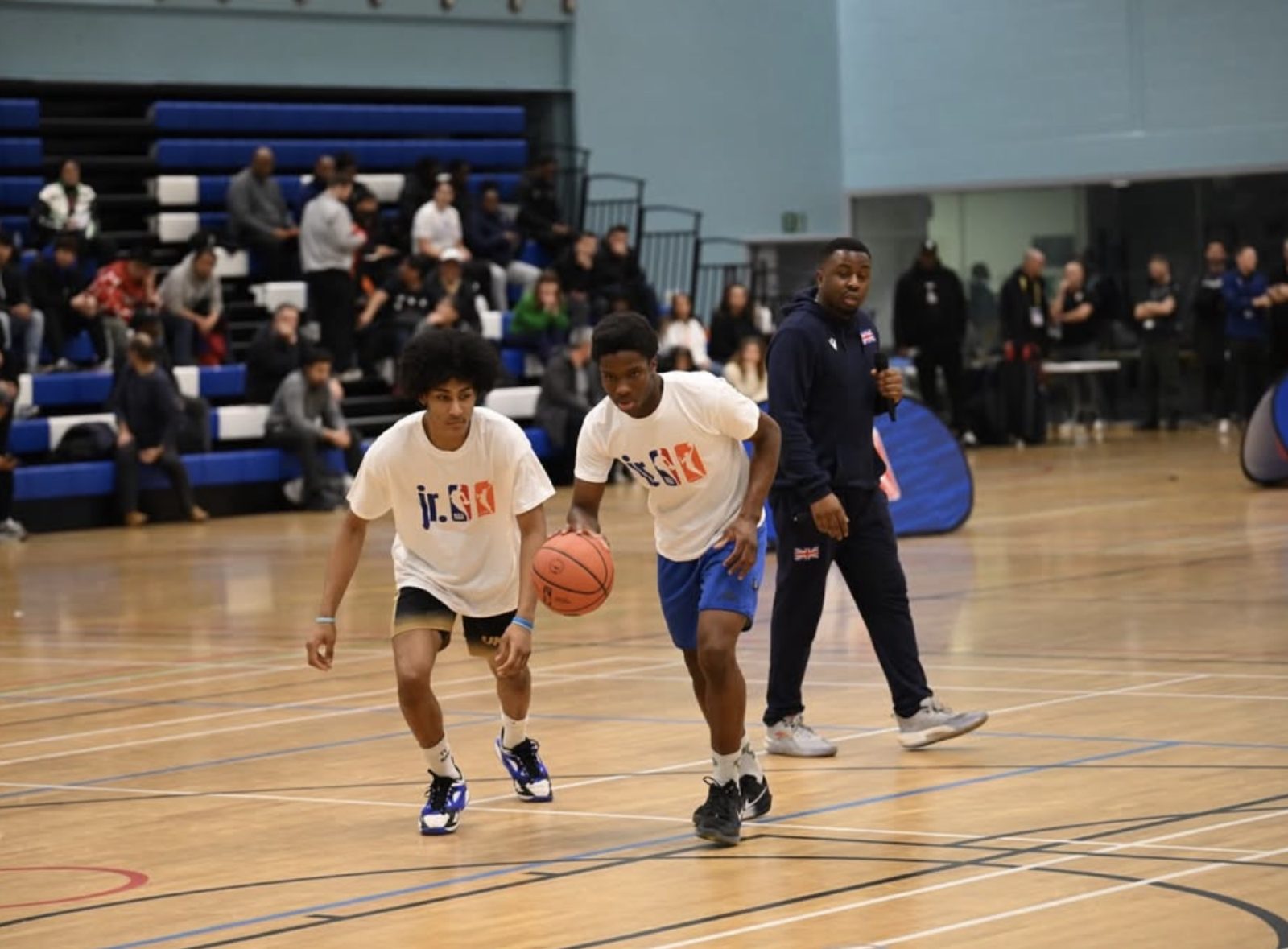 Players working through a dribbling drill in a sports hall