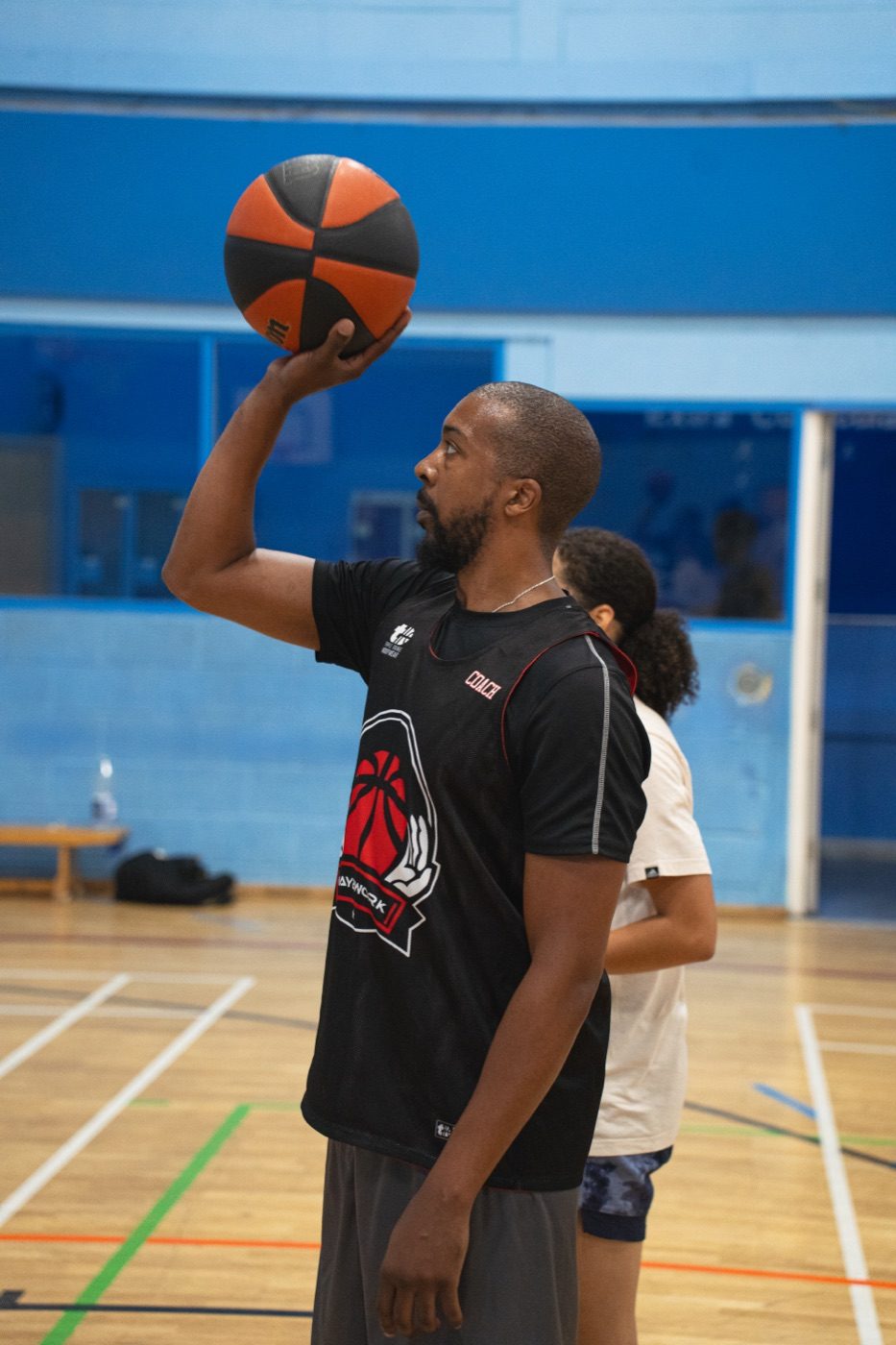 Coach demonstrating shooting form